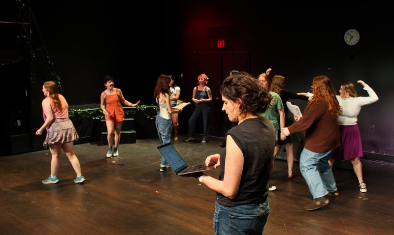 Group of people on stage during a performance.