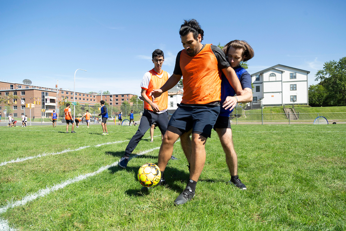 three players on a soccer field