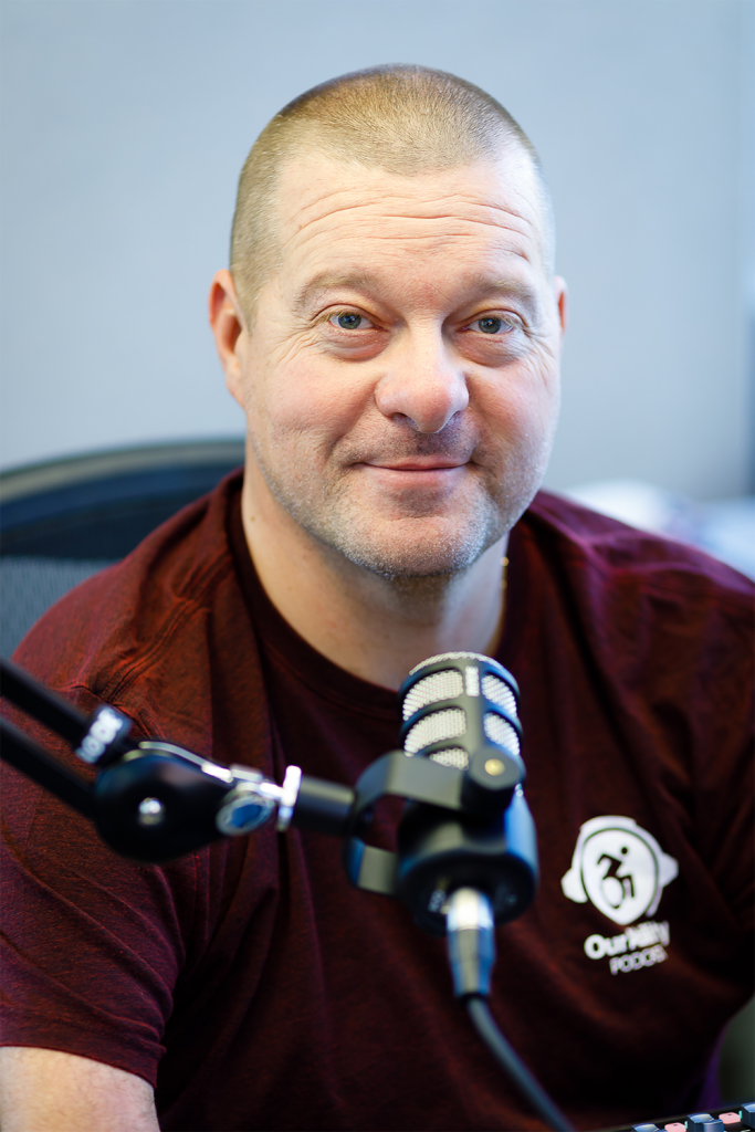 person seated in front of a microphone