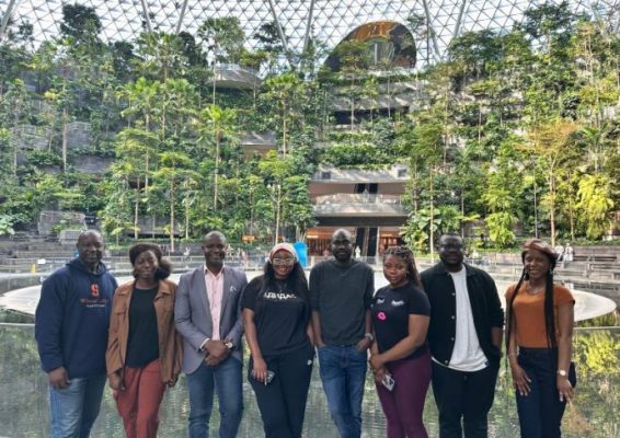 group of students pose at a unique outdoor garden