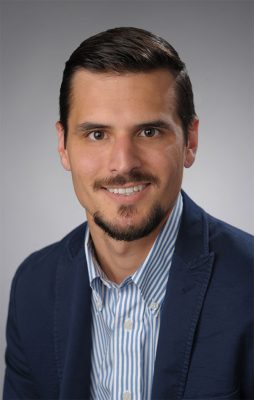 person wearing suit jacket and striped shirt 