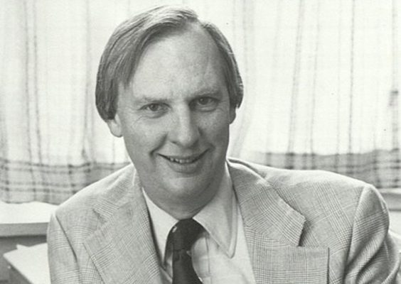 A man smiles while posing for a headshot.