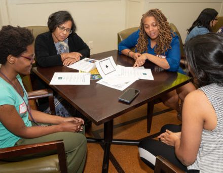 Small group of women having a discussion at a table 