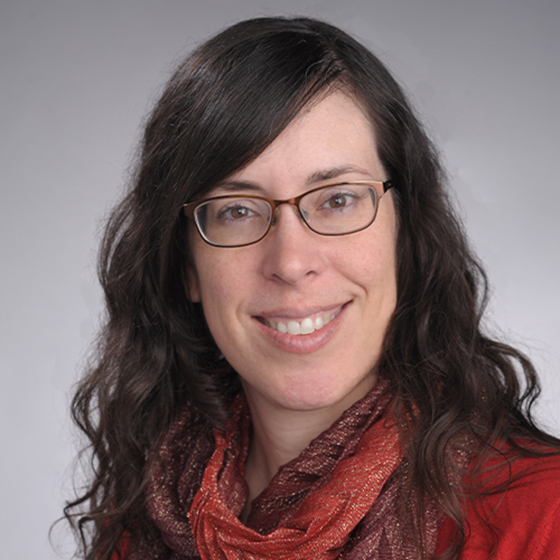 A woman smiles while posing for a headshot.