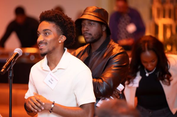 young person asking a question at a speaking event