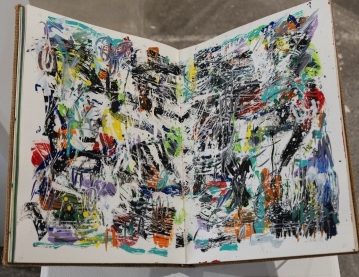 artist sketches of varied colors and lots of black and white across a double page