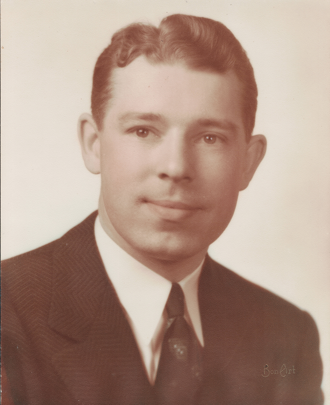 head shot of person wearing suit