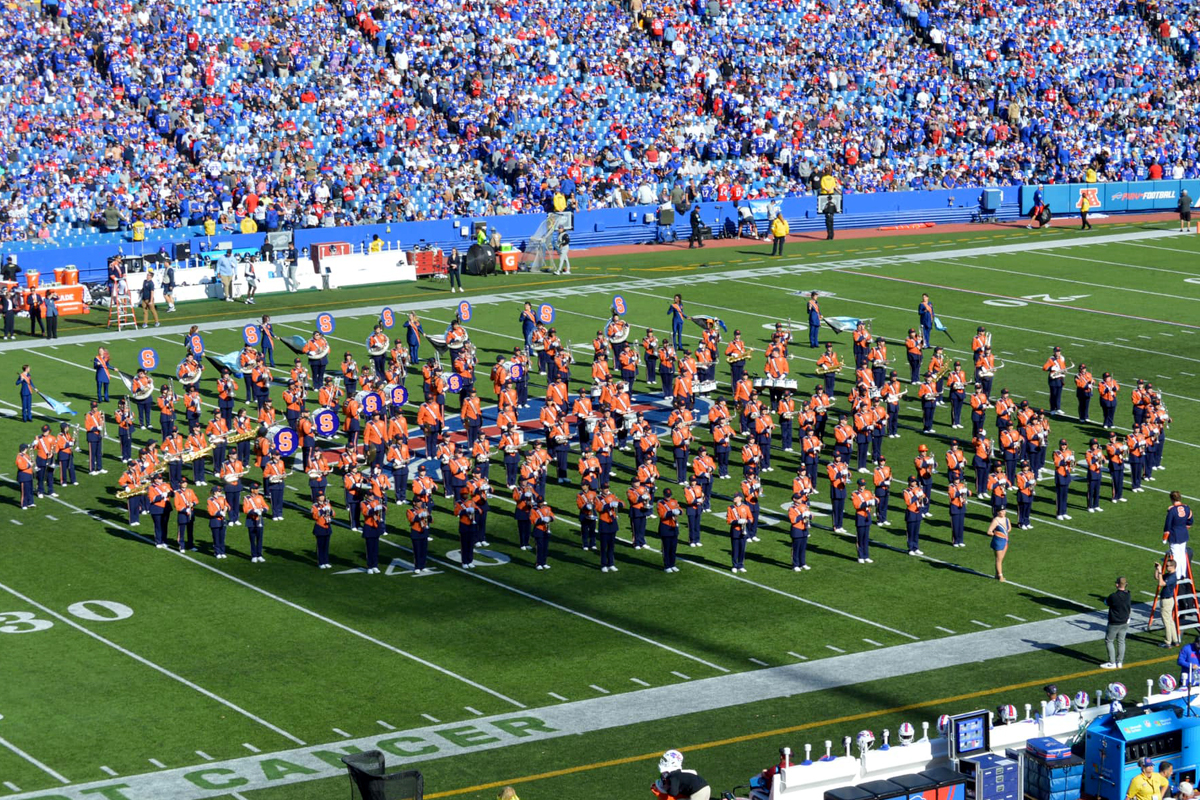 Members of the Syracuse University Marching Band perform at halftime of a Buffalo Bills game.