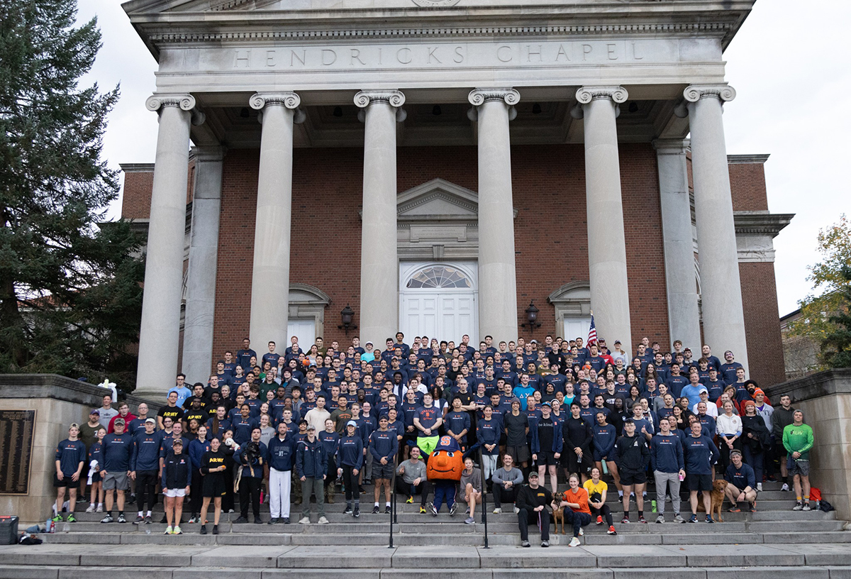 large group of people standing and sitting on steps of Hendricks Chapel