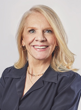 A woman smiles while posing for a headshot.