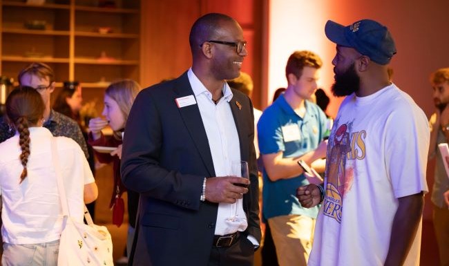 two men speaking at a reception