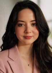 woman with dark hair slightly smiling