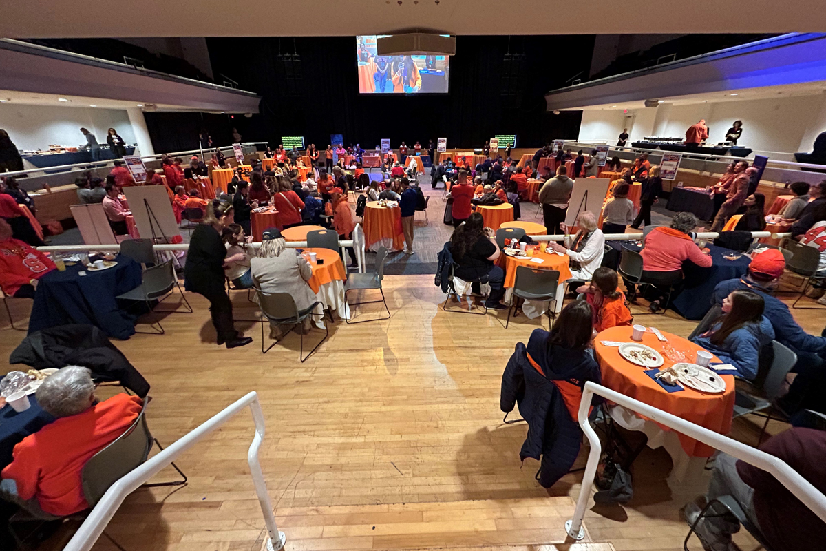 People eating breakfast during Syracuse University's Orange Central homecoming weekend.