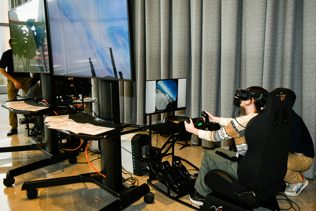 A woman participates in a flight simulation.