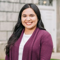 A woman smiles while posing for a headshot.