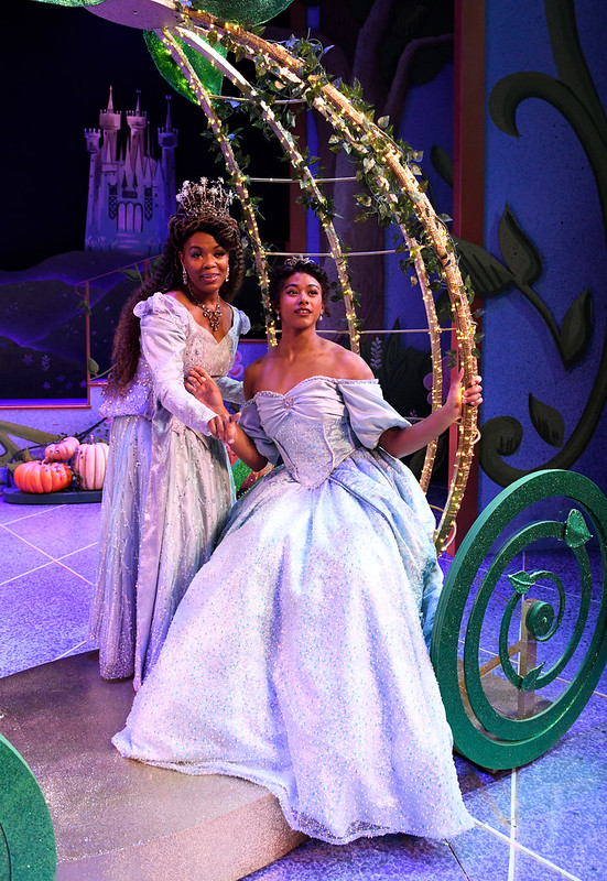 two people in ball gowns on a stage