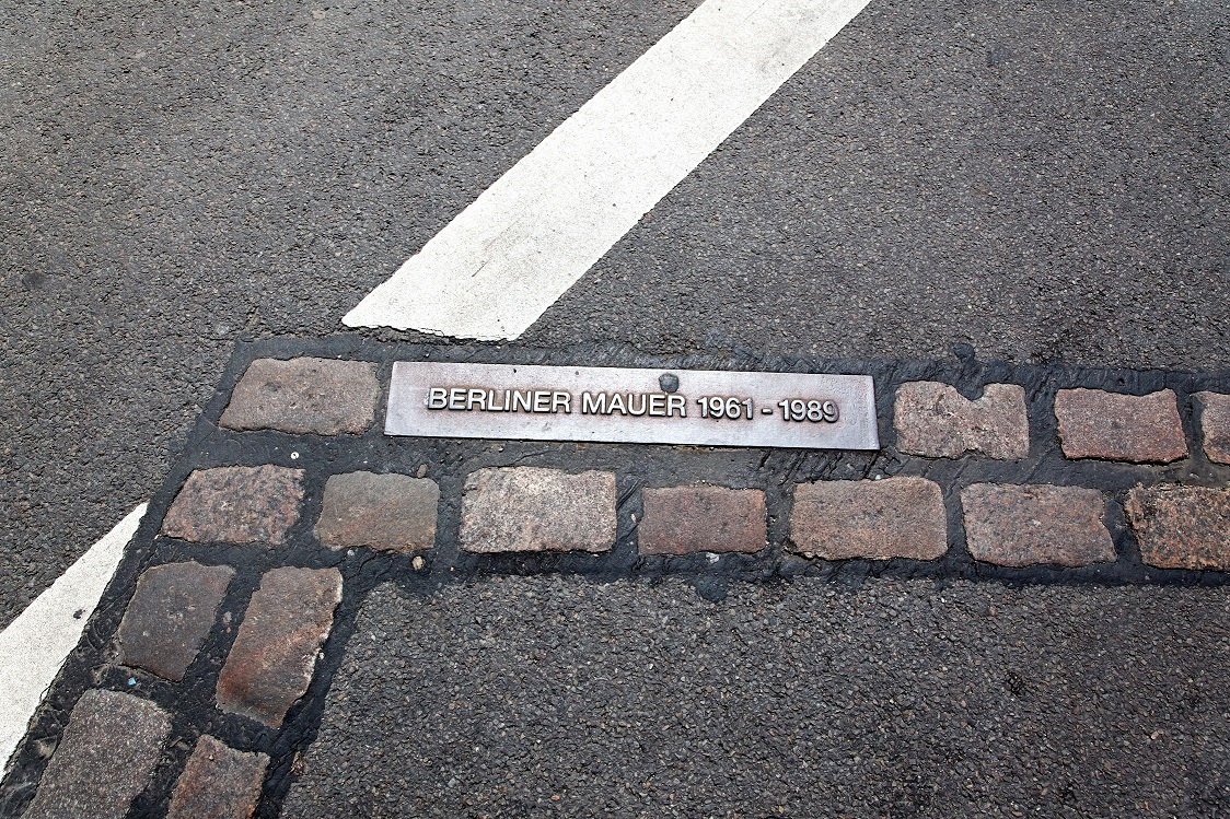 roadway with bricks marking Berlin Wall