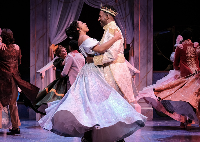 two people in formal wear dancing on a stage