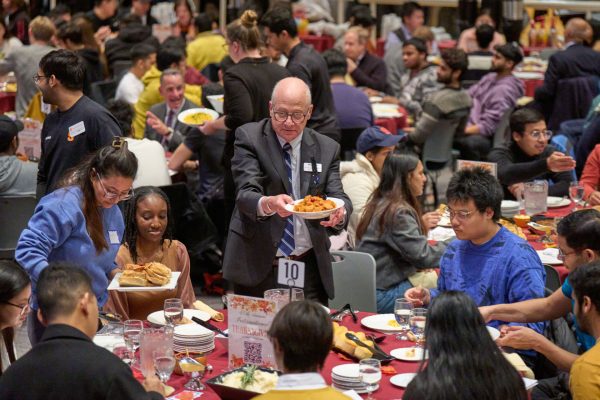 Dean Michael Tick serves to students at his table