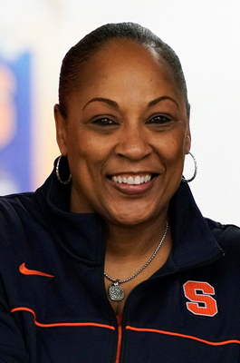 A woman smiles while posing for a headshot.