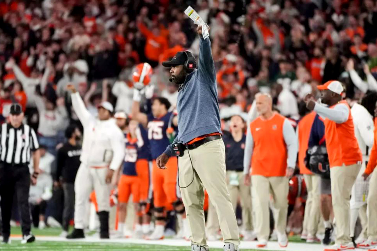 The Syracuse University football coach cheers on his team during a game inside the JMA Wireless Dome.