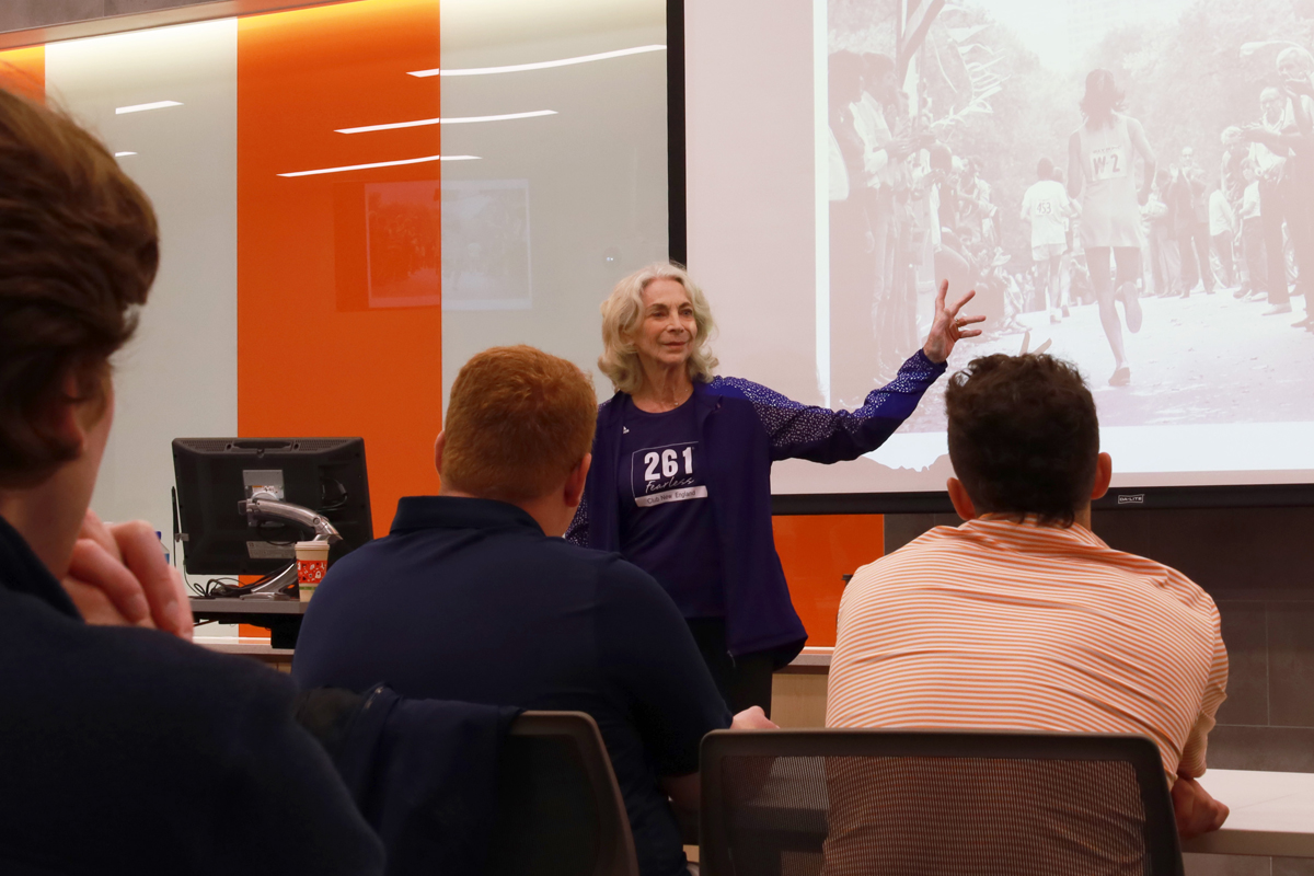 A woman speaks to a classroom full of students in the Falk College.