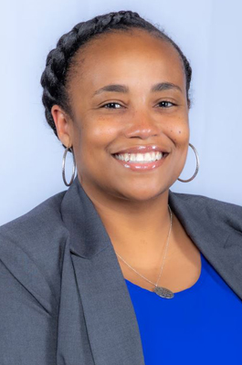 A woman smiles while posing for a headshot.