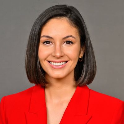 A woman smiles while posing for a headshot.