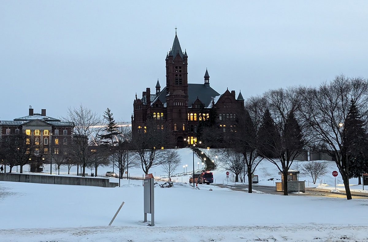 An exterior view of the Crouse College building at Syracuse University at dusk, in the winter