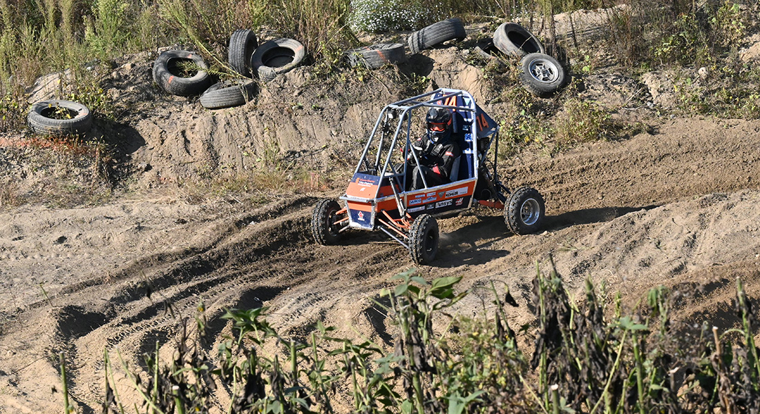 A student drives an off-road vehicle.