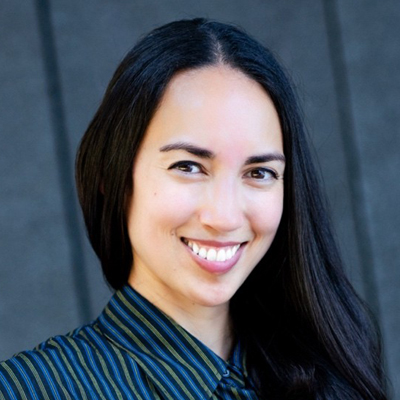 A woman smiles while posing for a headshot.