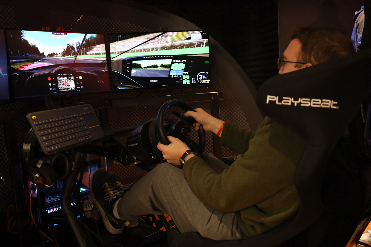 A man tries out a racing simulator in the gaming and esports center.