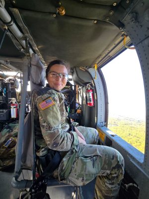 Madison Kaifas-Steiner, a 2nd Lieutenant in the Army National Guard, riding in an MH-60 Blackhawk Helicopter while serving as a medical officer.