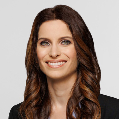 A woman smiles while posing for a headshot.