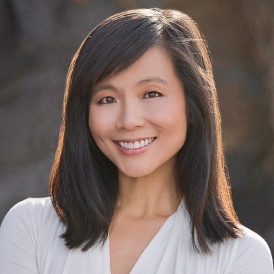 A woman smiles while posing for a headshot.