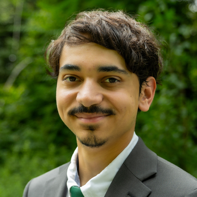 A man smiles while posing for a headshot.