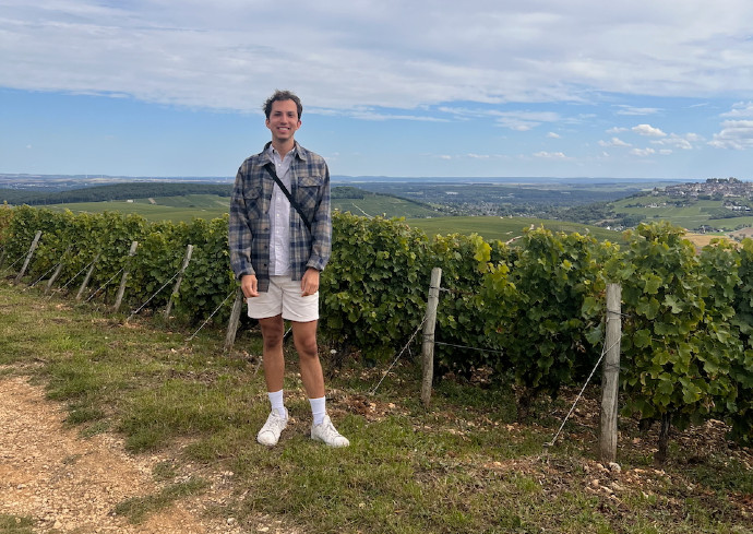 Man standing in front of a vineyard