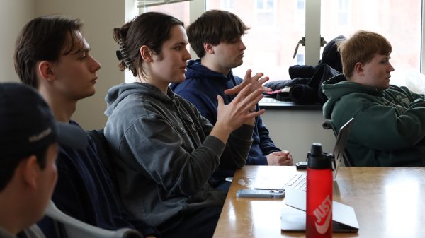 Sport Analytics student Sebastian Bush (center).