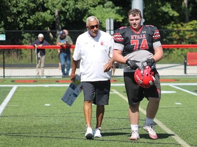 Carl Sanfilippo on the field with a player