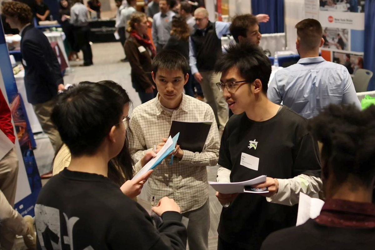 Students mingle with employers during a job fair.