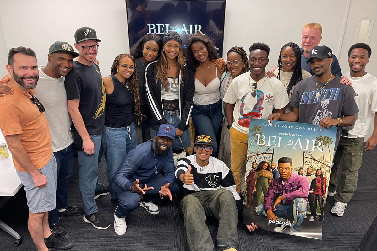 Cast members from the television show "Bel-Air" pose for a group photo on the set.