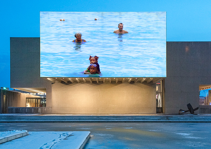 a video screen on the outside of the Everson Museum