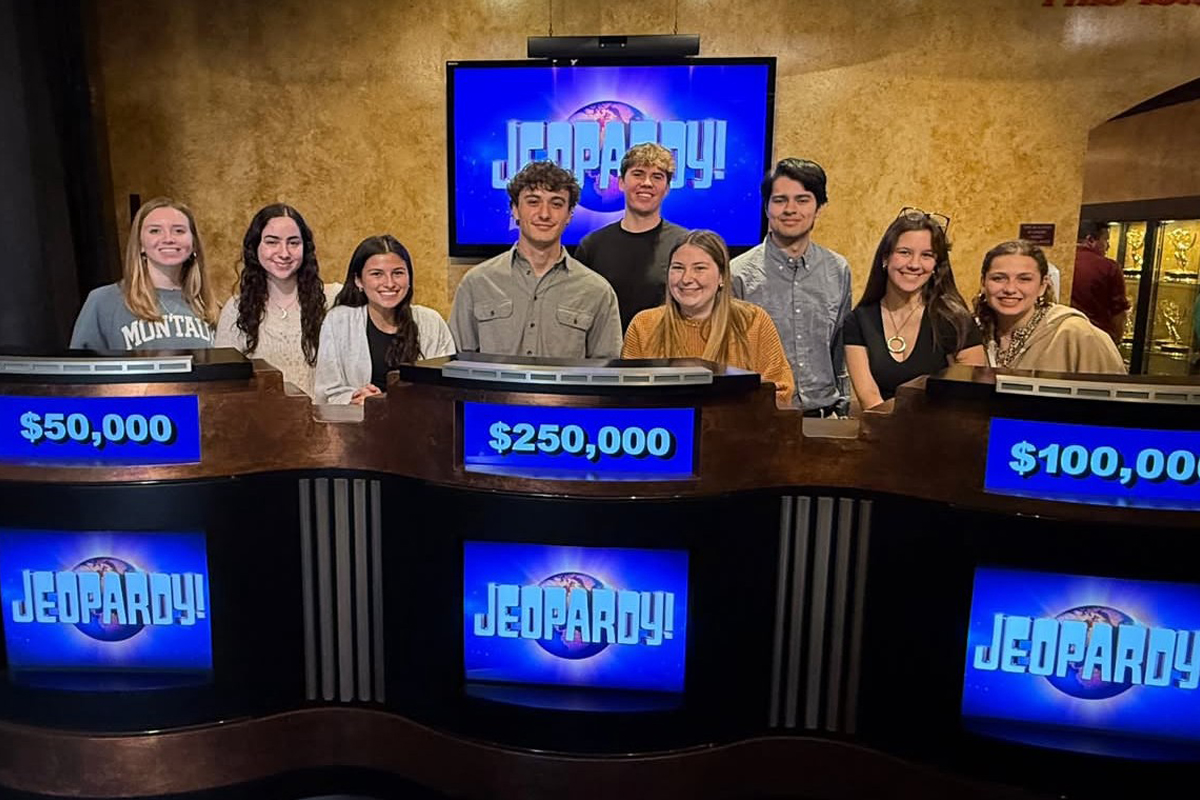 Students smile while posing on the set of "Jeopardy!"