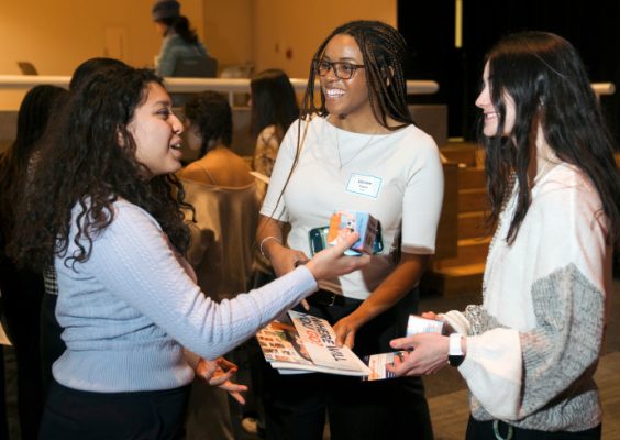 Three students mingle at Success Scholars reception