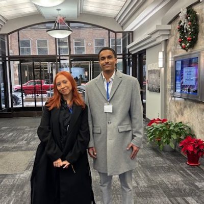 two people standing in a building's lobby