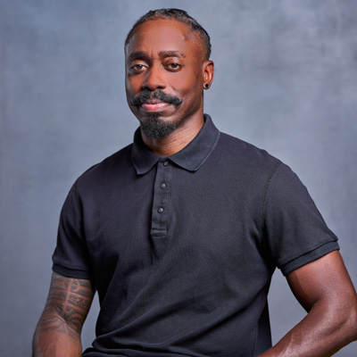 A professor smiles while posing for a headshot.