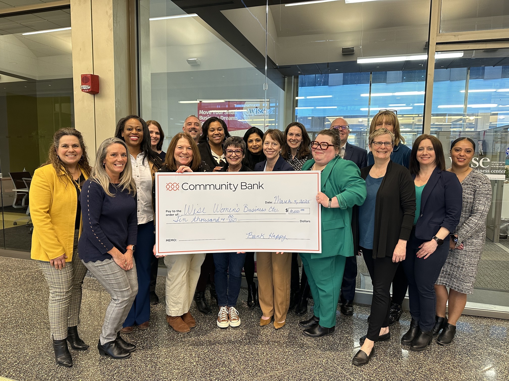 group of people holding an oversized check