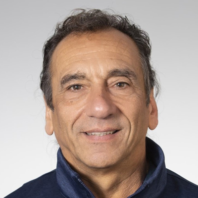 A man smiles while posing for a headshot.