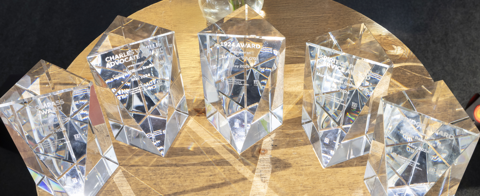 Three awards are positioned on a desk.