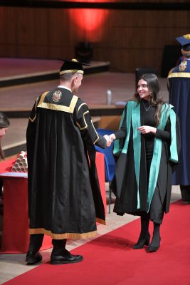 Maggie Sardino walks the stage during King’s College London’s graduation ceremony, having earned her degree in digital humanities.